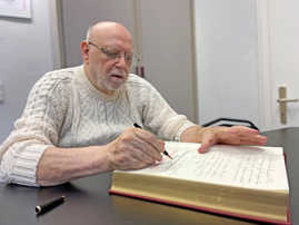 Der 80-jährige Horst Schlösser kalligrafiert einen Eintrag im Gästebuch der Stadt Trier.