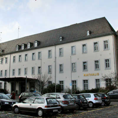 Vorderansicht des Rathauses am Augustinerhof mit dem Haupteingang und dem Chor der alten Augustinerkirche (rechts).