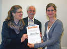 Bürgermeisterin Angelika Birk und Rudolf Hahn, Leiter des städtischen Bildungs- und Medienzentrums, überreichen Melanie Rausch ihr Zertifikat.