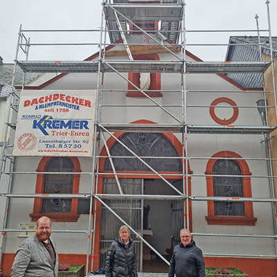 Der auch für Denkmalpflege zuständige Kulturdezernent Markus Nöhl, Dr. Angelika Meyer (Amt für Stadtkultur und Denkmalschutz) und Andreas Bayer (Hochbauamt, v. l.) informieren sich über die Bauarbeiten an dem Glockenturm im obersten Teil der Medard-Kapelle. 