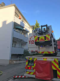 Die Feuerwehr rettet eine Frau über den Balkon aus ihrer brennenden Wohnung.