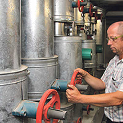 Hausmeister Uwe Mischtian bedient eine Heizpumpe im Keller des Rathauses. Eine Modernisierung der zugehörigen Regelungstechnik wird im Klimaschutzkonzept empfohlen.