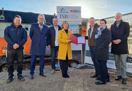 Finanz- und Bauministerin Doris Ahnen überreicht den ISB-Förderbescheid auf der Baustelle in Trier-West an das Investorenehepaar Ursula und Thomas Arndt.