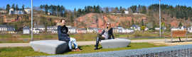 Sarah Schmitz und Loretta Schulte genießen die ersten warmen Sonnenstrahlen auf den neuen Sitzsteinen am Zurlaubener Ufer