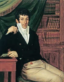 Das Gemälde zeigt einen sitzenden Mann vor einem Bücherregal. Er trägt eine schwarze Weste über einem weißen Hemd mit hochstehendem Kragen und hält ein Buch in der Hand