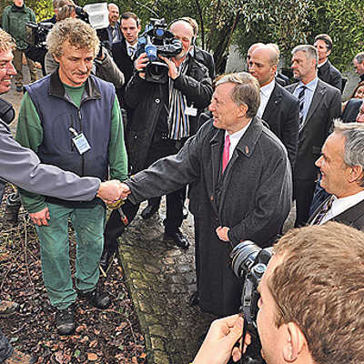 Wenige Minuten nach seiner Ankunft in Trier kommt Horst Köhler im Rautenstrauchpark mit Gartenarbeitern des Bürgerservice ins Gespräch.