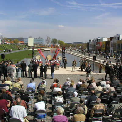 Bei bestem Frühlingswetter startete am 22. April 2004 die Landesgartenschau in Trier. Dazu gehörte eine Eröffnungsshow unter dem Motto „Zauber der Elemente“. Vor zahlreichen Gästen trat unter anderem eine Trommlergruppe am Wasserband auf. Dieser Bereich wurde schnell zu einer zentralen Flaniermeile.