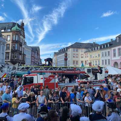 Die Feuerwehr transportiert den Oberbürgermeister Leibe und die Weinkönigin Melika mithilfe einer Drehleiter traditionsgemäß zur Schmückung des Stadtpatrons Petrus auf dem Hauptmarkt.