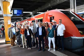Die Trierer Delegation und die Metzer Gastgeber stehen vor dem Zug im Bahnhof Metz.