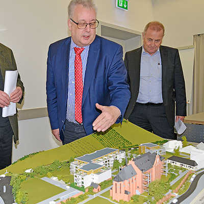 Baudezernent Andreas Ludwig (Mitte) bespricht mit Alois Peters (l.) und Hermann Schmitz von Eifelhaus an einem Modell die Planungen für das Klostergelände.